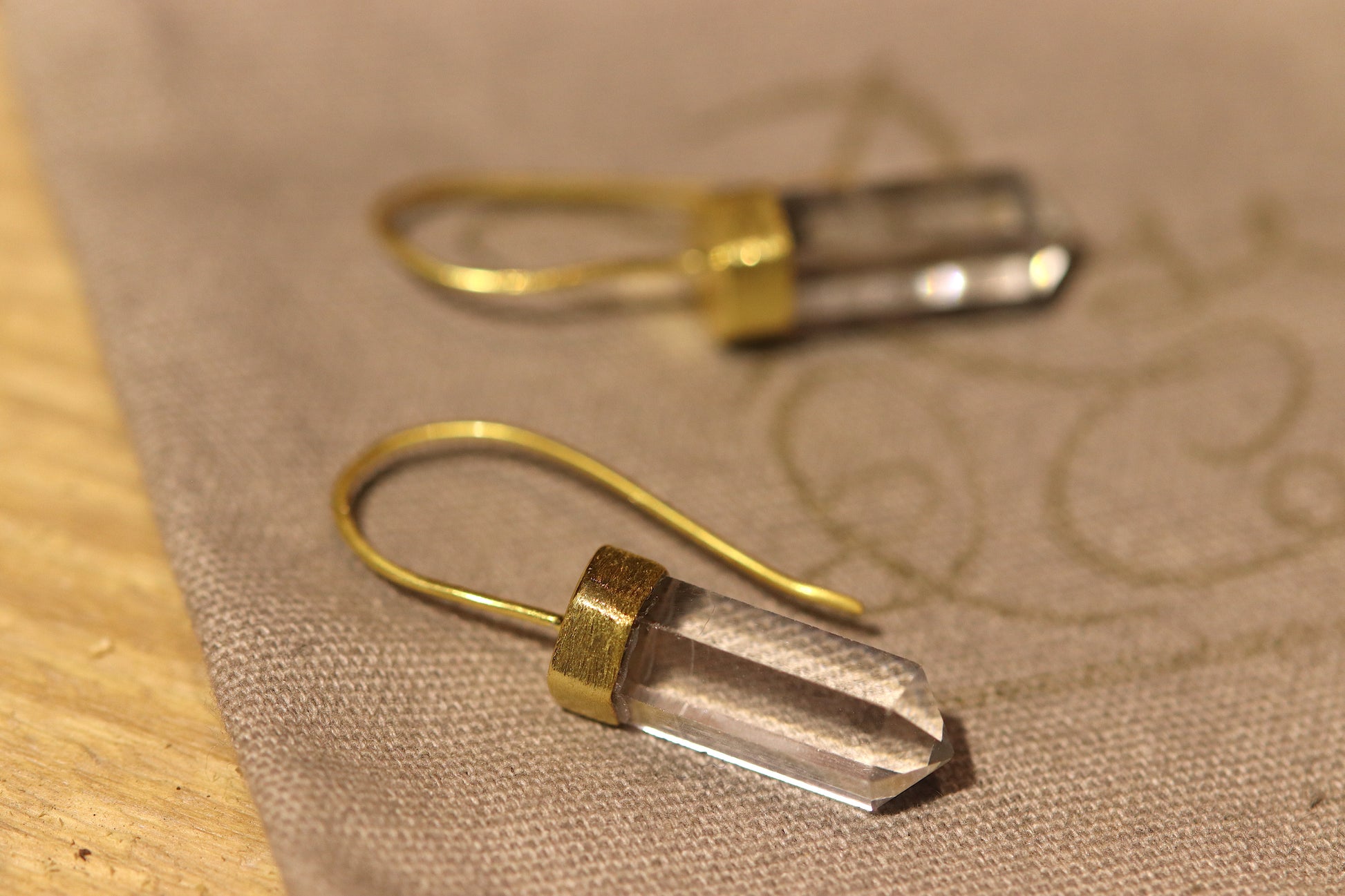 Gold plated earrings with a clear crystal point. 