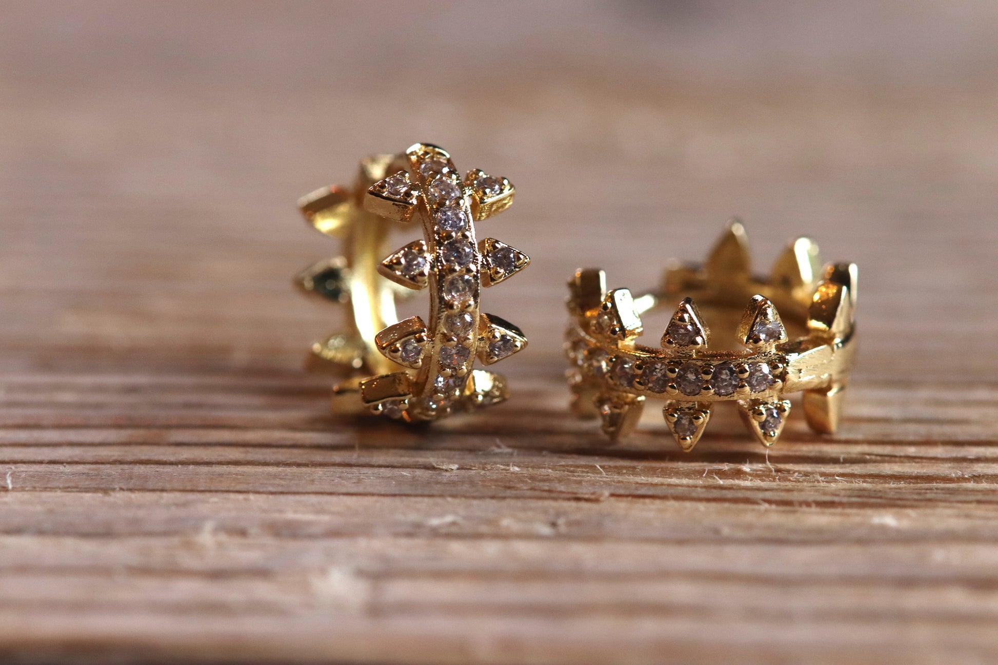 Brass Huggie Earrings With Cubic Zirconi & Spikes on wood. Small Hoop Earrings. 