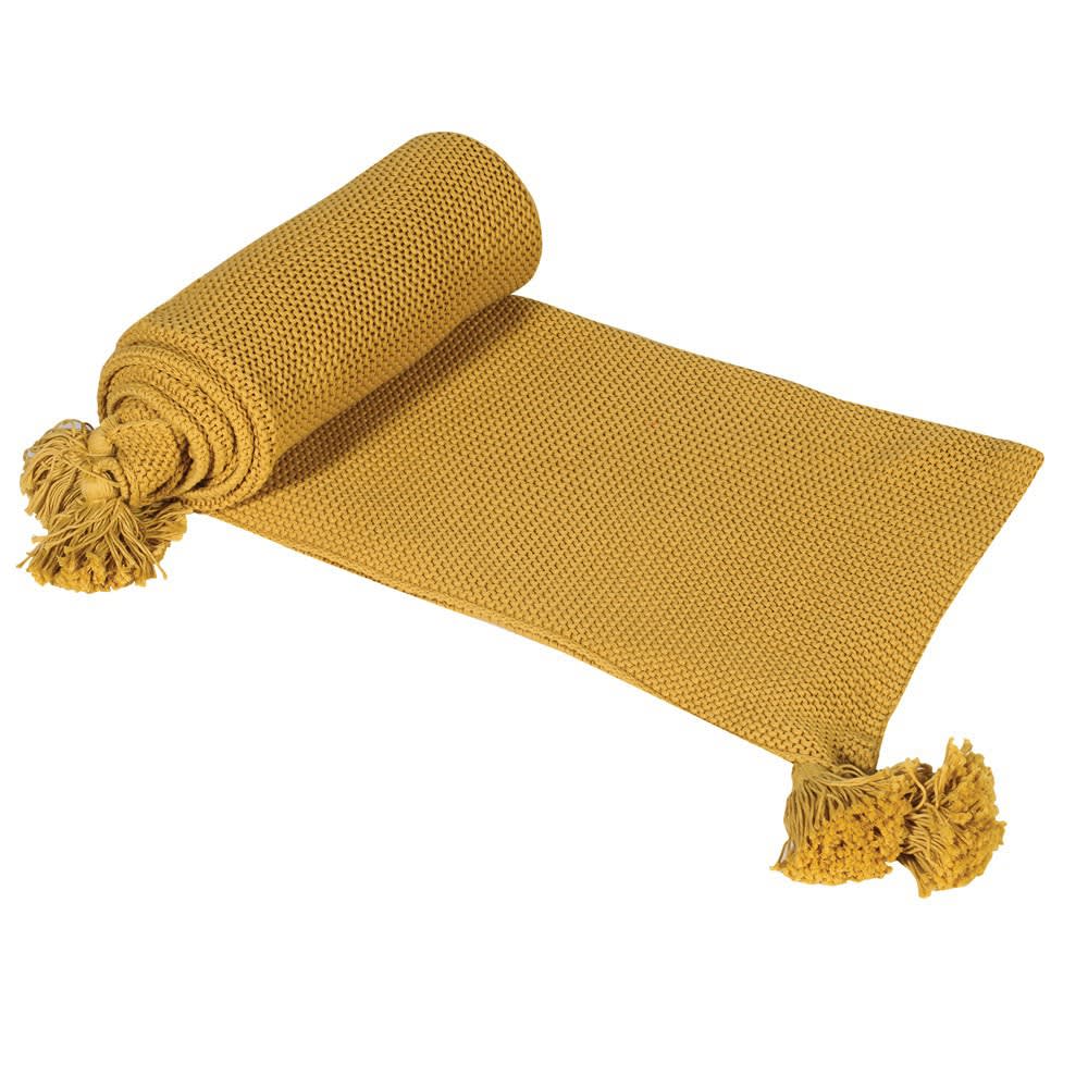 Mustard yellow throw with big yellow tassels on a white background.