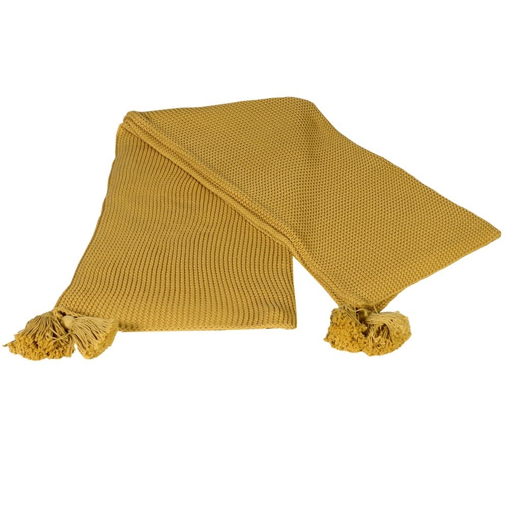 Chunky knitted yellow mustard throw with 4 large tassels on a white background.